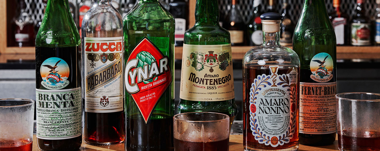 Bottles of liquor and liquor glasses on bar top